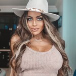 Hat on, confidence up—she's ready to conquer the world.